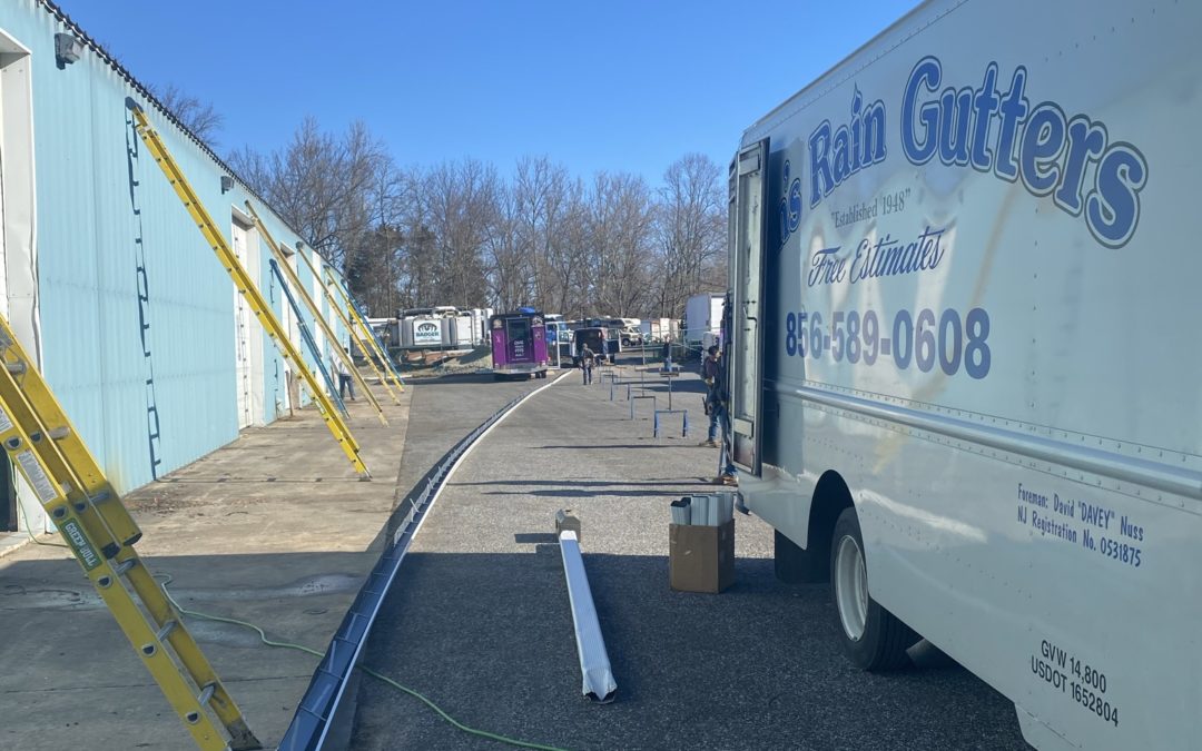 van's rain gutters truck onsite with seamless gutters being installed best gutter company near me