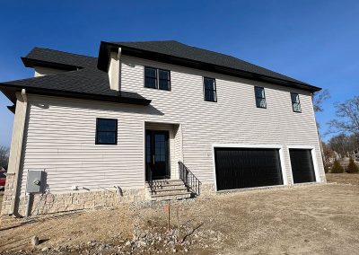 view of back of house with black gutters and two garages van's rain gutters south jersey mullica hill nj