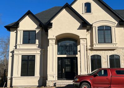 entrance view of house with installed black gutters and red truck parked out front mullica hill nj van's rain gutters south jersey