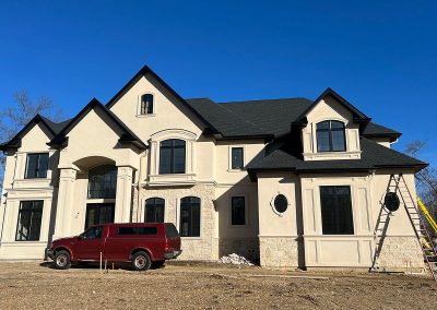 house with new black gutters with red truck parked in front and ladders set up along the walls mullica hill nj van's rain gutters south jersey