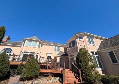 wooden stairway leading to house with white gutter installation shamong nj van's rain gutters south jersey