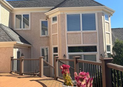 deck decorated with flower pots with a view of new white gutter system in shamong nj van's rain gutters south jersey
