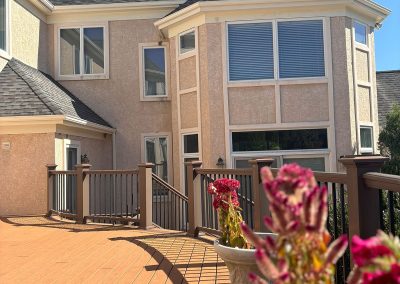 deck view in backyard of house focusing on new white seamless gutter system shamong nj van's rain gutters south jersey