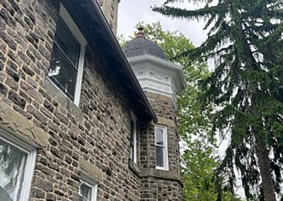 ground view of historic house with turret in woodbury nj van's rain gutters south jersey