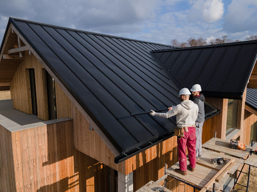 roof contractors working on new roofing van's rain gutters debris in gutters
