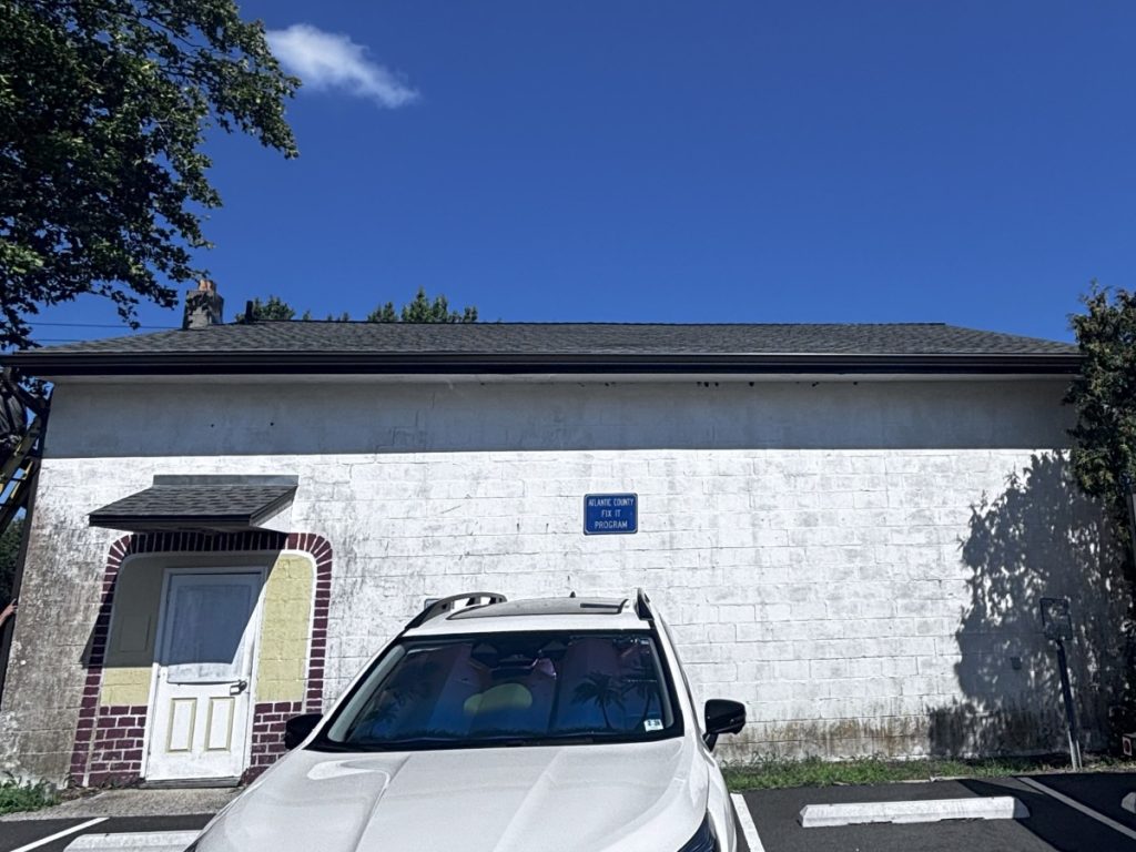 black commercial gutters on white building van's rain gutters